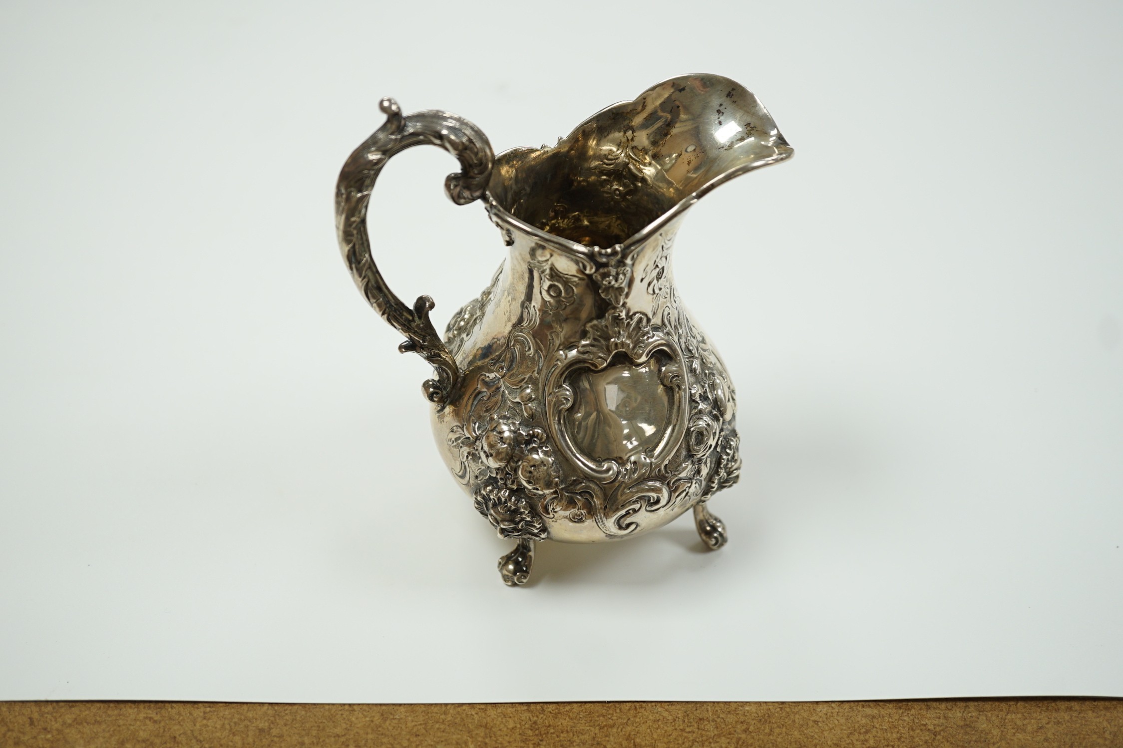 A Victorian embossed silver baluster cream jug, Robert Harper, London, 1862, height 15.1cm, 8.6oz.